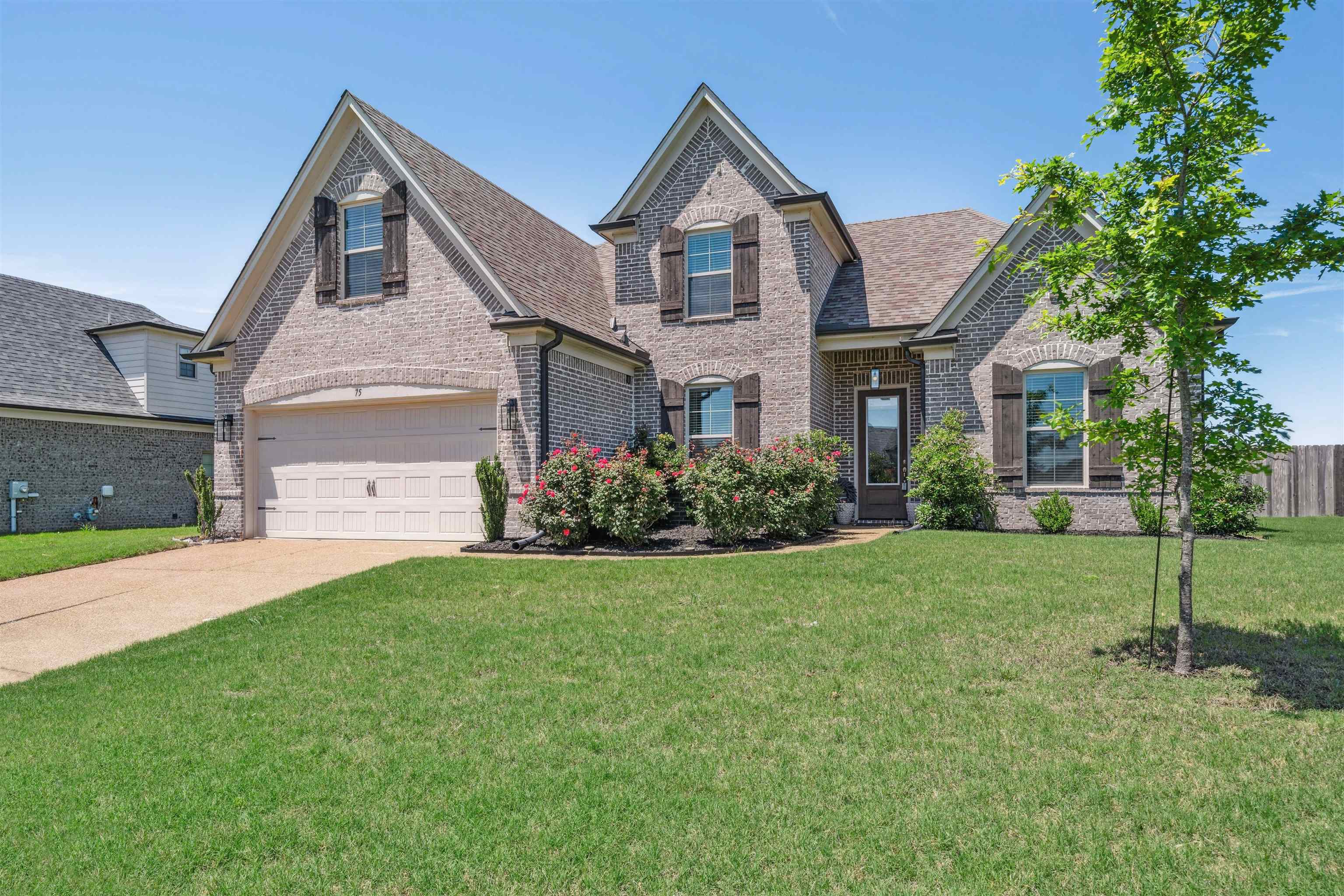 75 Cypress Point Road Oakland, TN 38060 - Photo 1 of 38 a front view of a house with a yard and garage