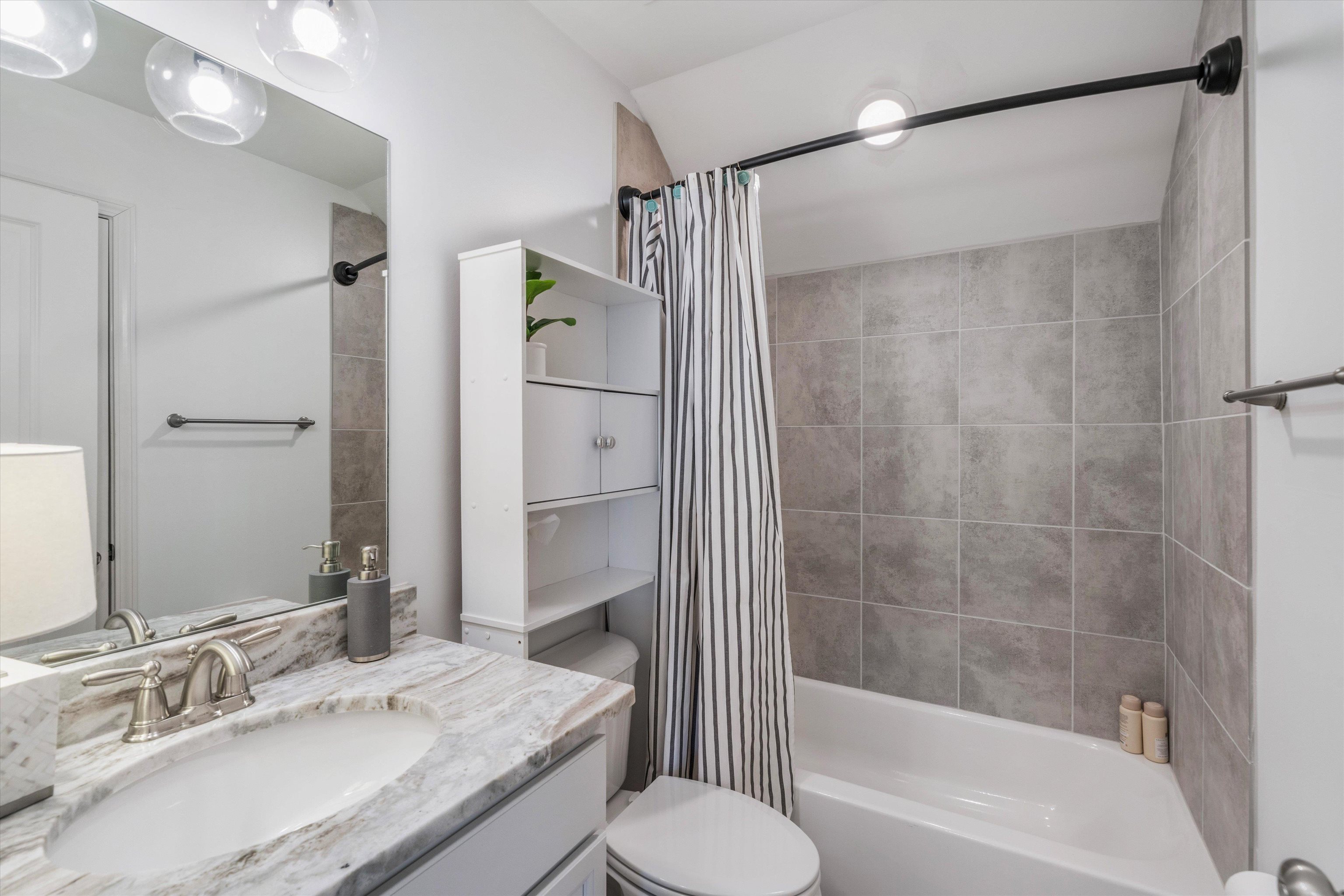 75 Cypress Point Road Oakland, TN 38060 - Photo 23 of 38 a bathroom with a granite countertop bathtub shower sink vanity and toilet