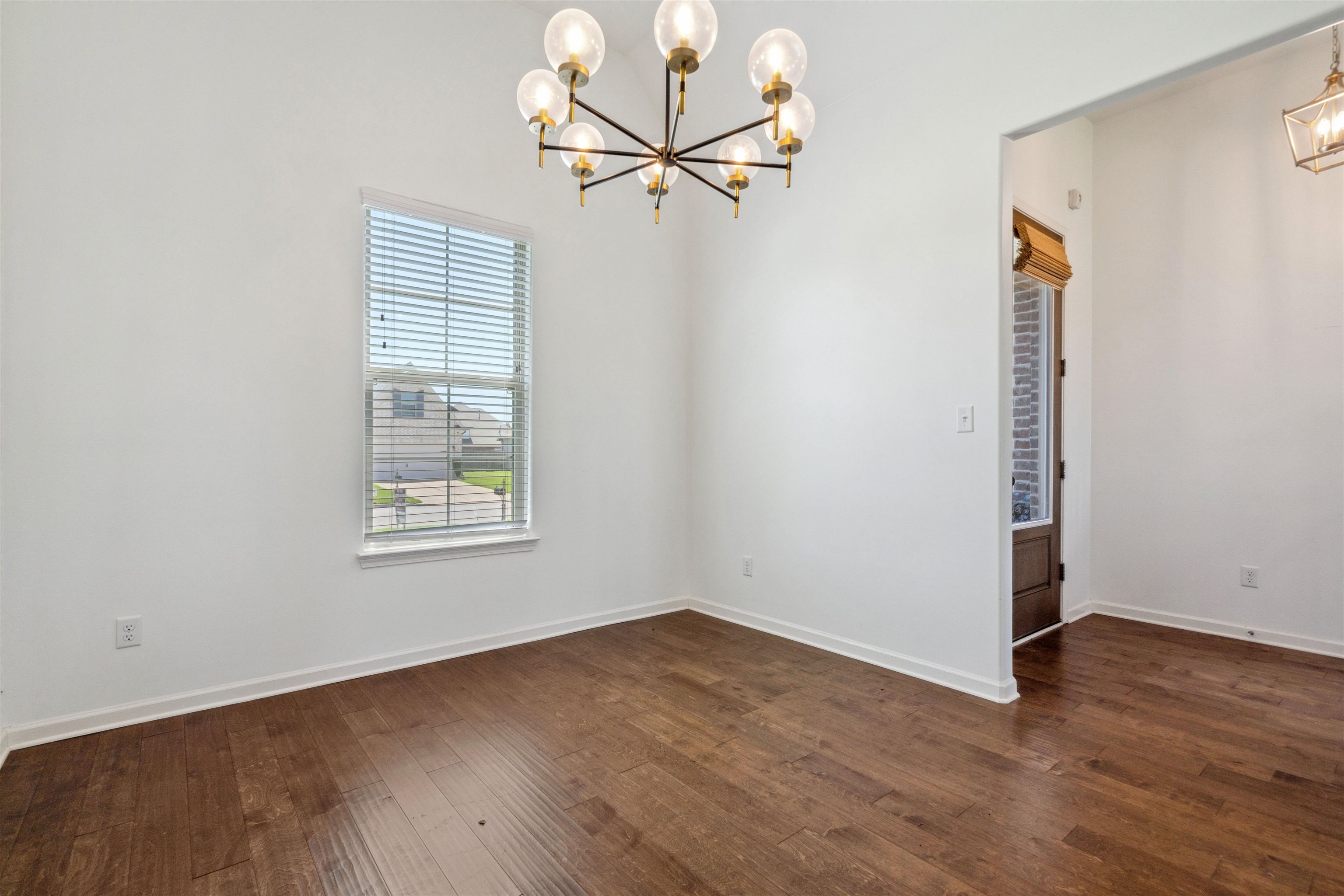 75 Cypress Point Road Oakland, TN 38060 - Photo 29 of 38 an empty room with wooden floor fan and windows