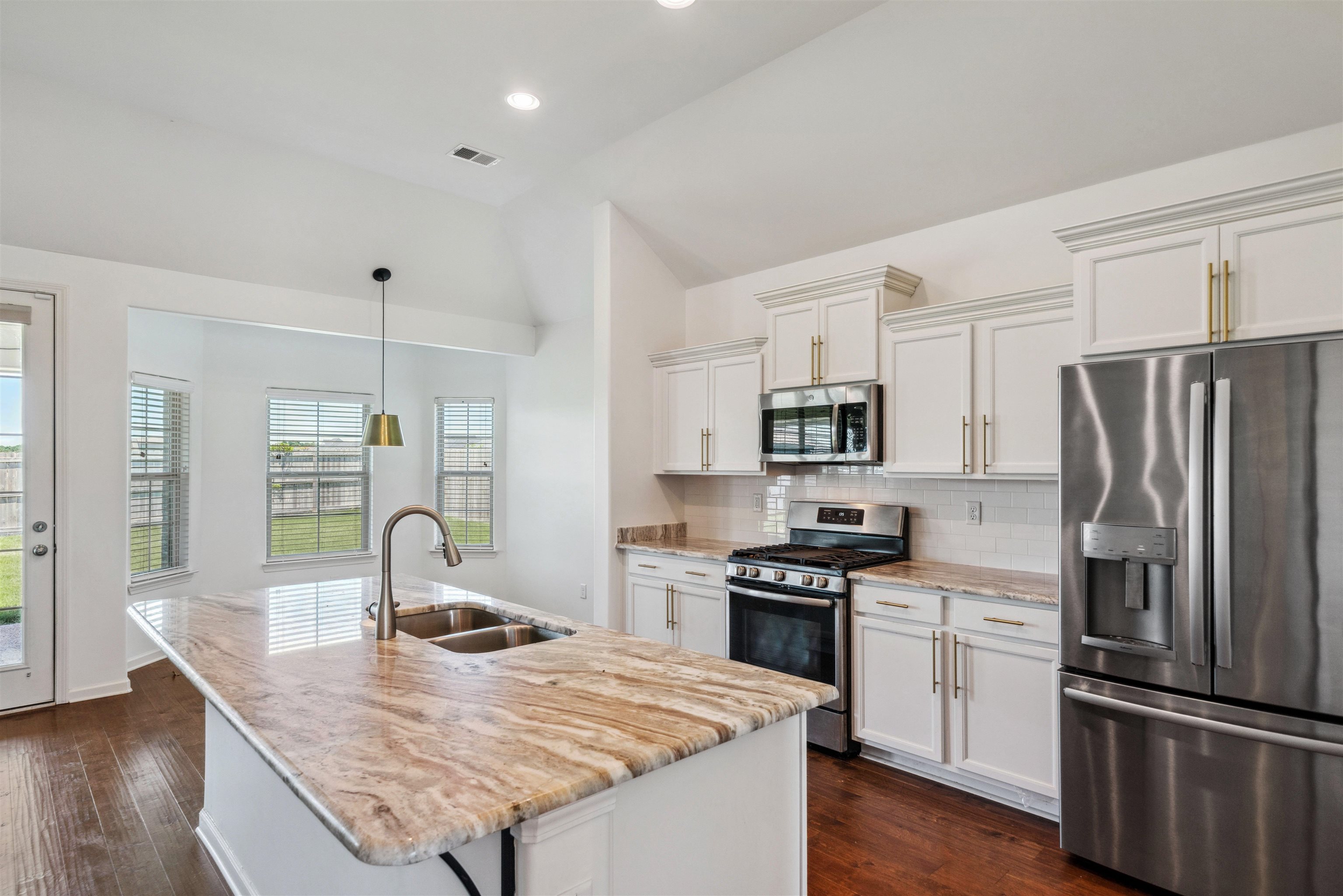 75 Cypress Point Road Oakland, TN 38060 - Photo 35 of 38 a kitchen with stainless steel appliances granite countertop a sink stove and refrigerator