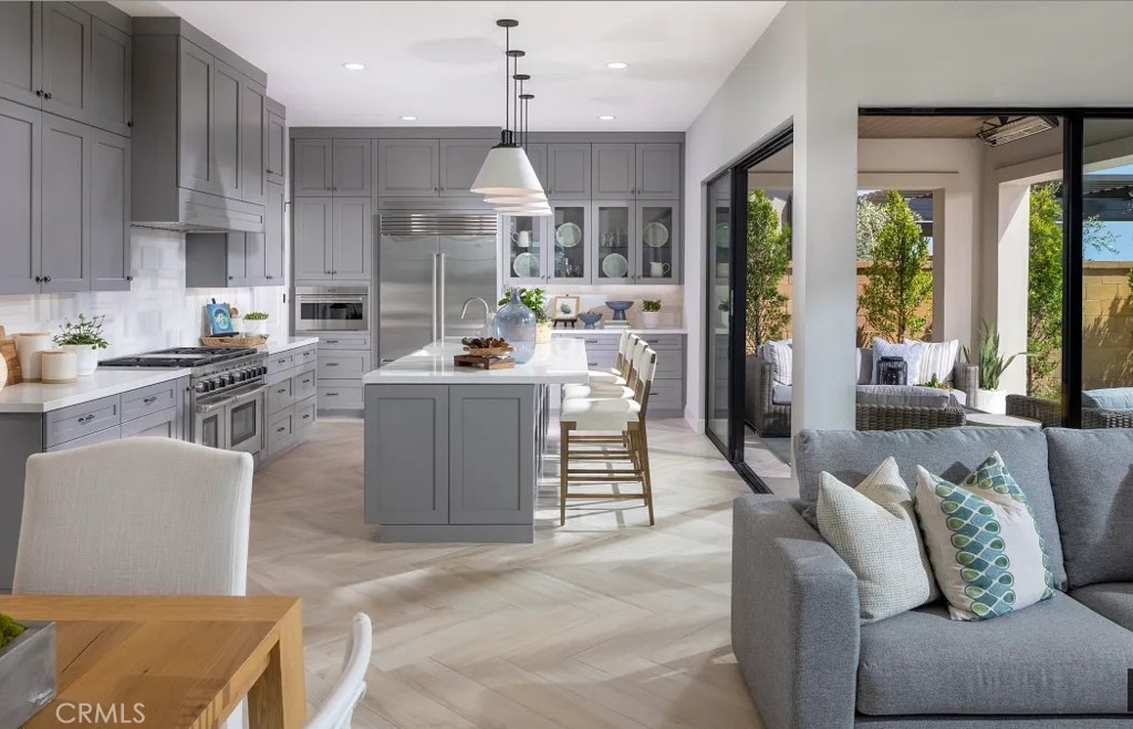 416 Milpas Irvine, CA 92602 - Photo 2 of 7 a living room with furniture a large window and stainless steel appliances