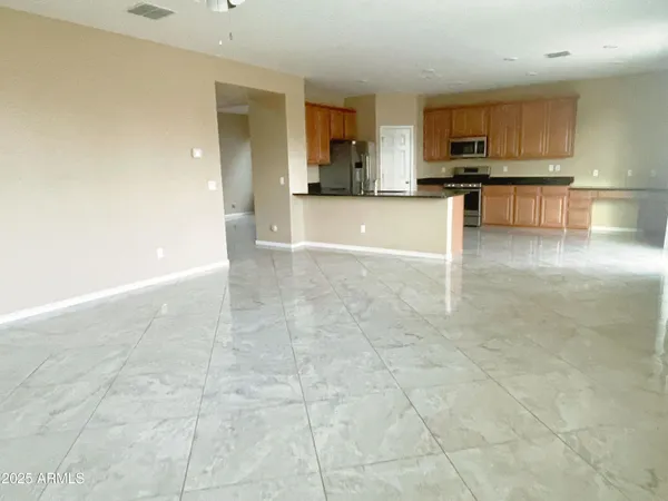 a view of a kitchen with a sink a counter top space and cabinets