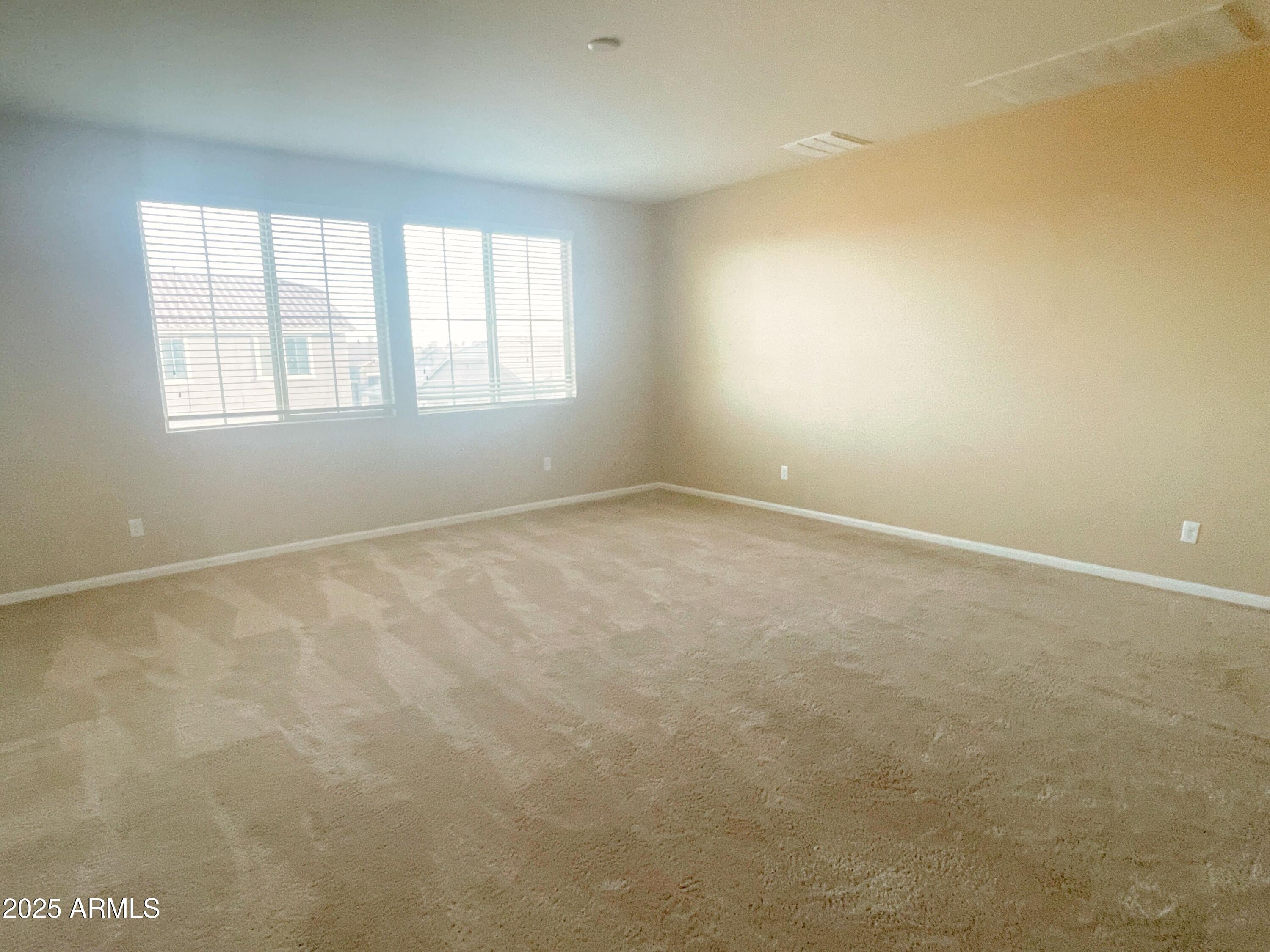 1121 East Regent Drive Gilbert, AZ 85298 - Photo 10 of 23 an empty room with windows