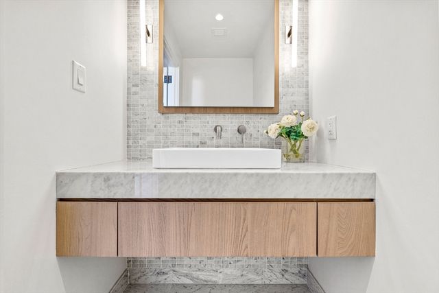 a bathroom with a sink and a mirror