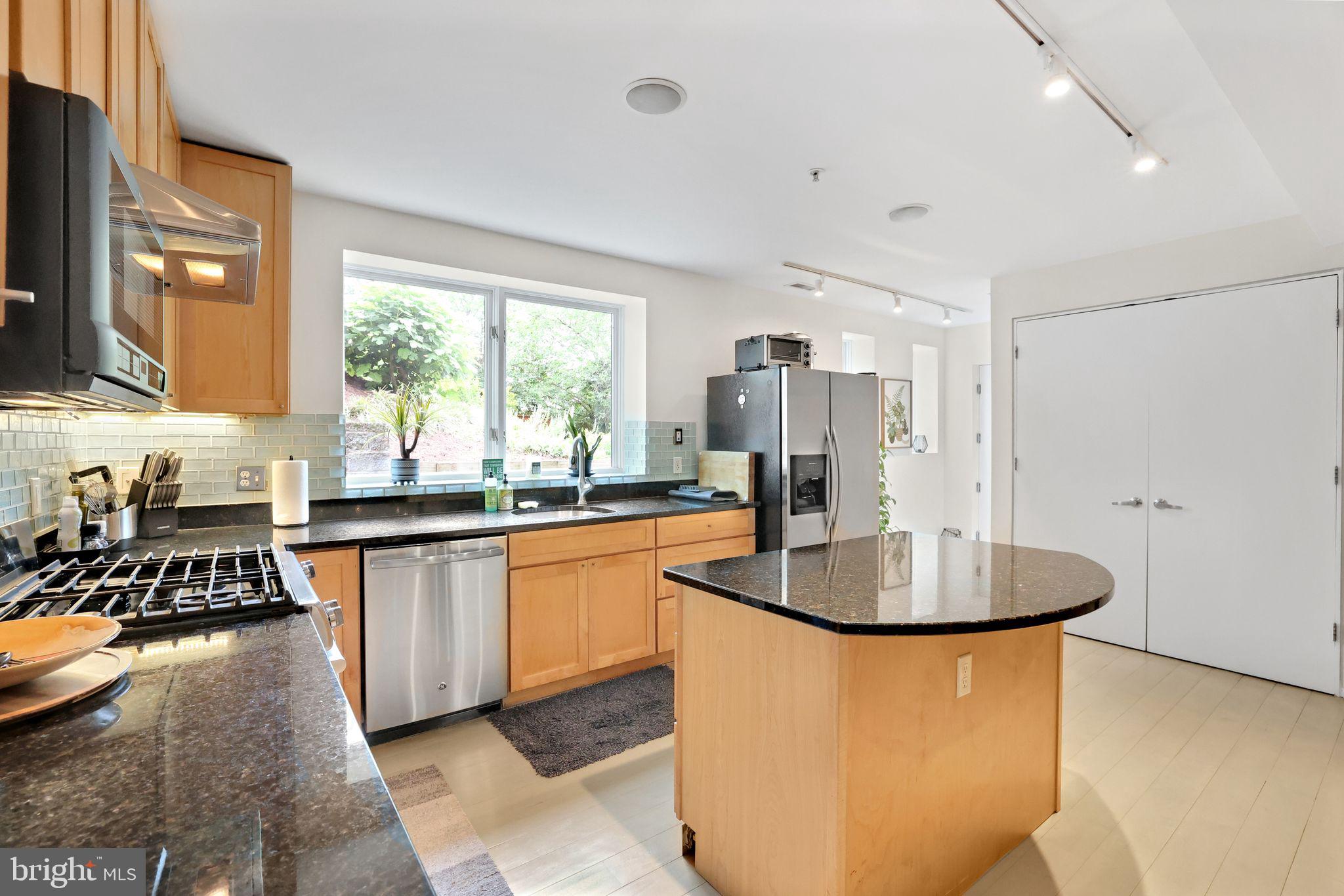 2311 15th Street Northwest, Unit 2 Washington, DC 20009 - Photo 11 of 37 a kitchen with stainless steel appliances granite countertop a sink a stove and a refrigerator