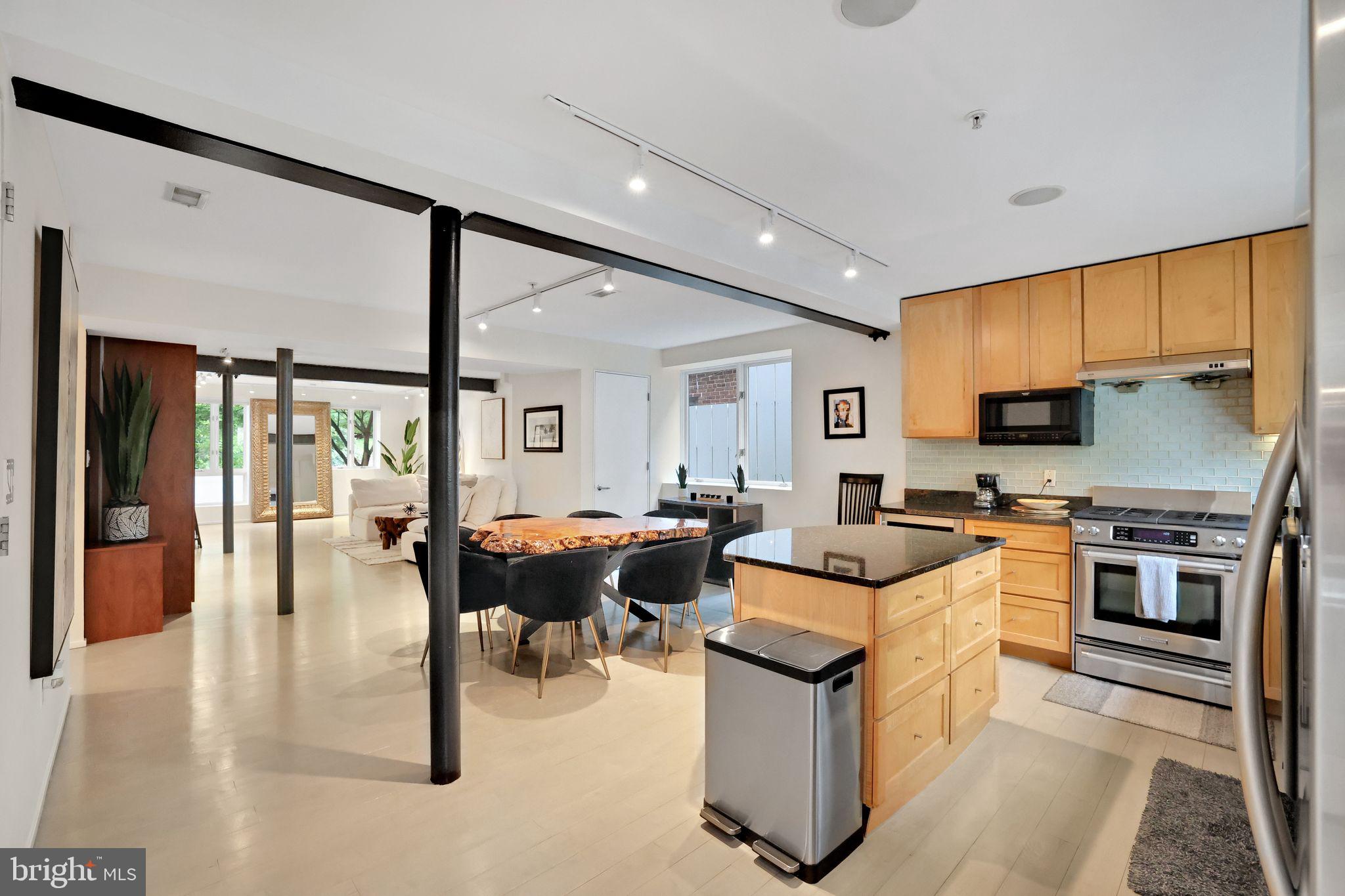 2311 15th Street Northwest, Unit 2 Washington, DC 20009 - Photo 14 of 37 a living room with stainless steel appliances furniture a rug and a kitchen view