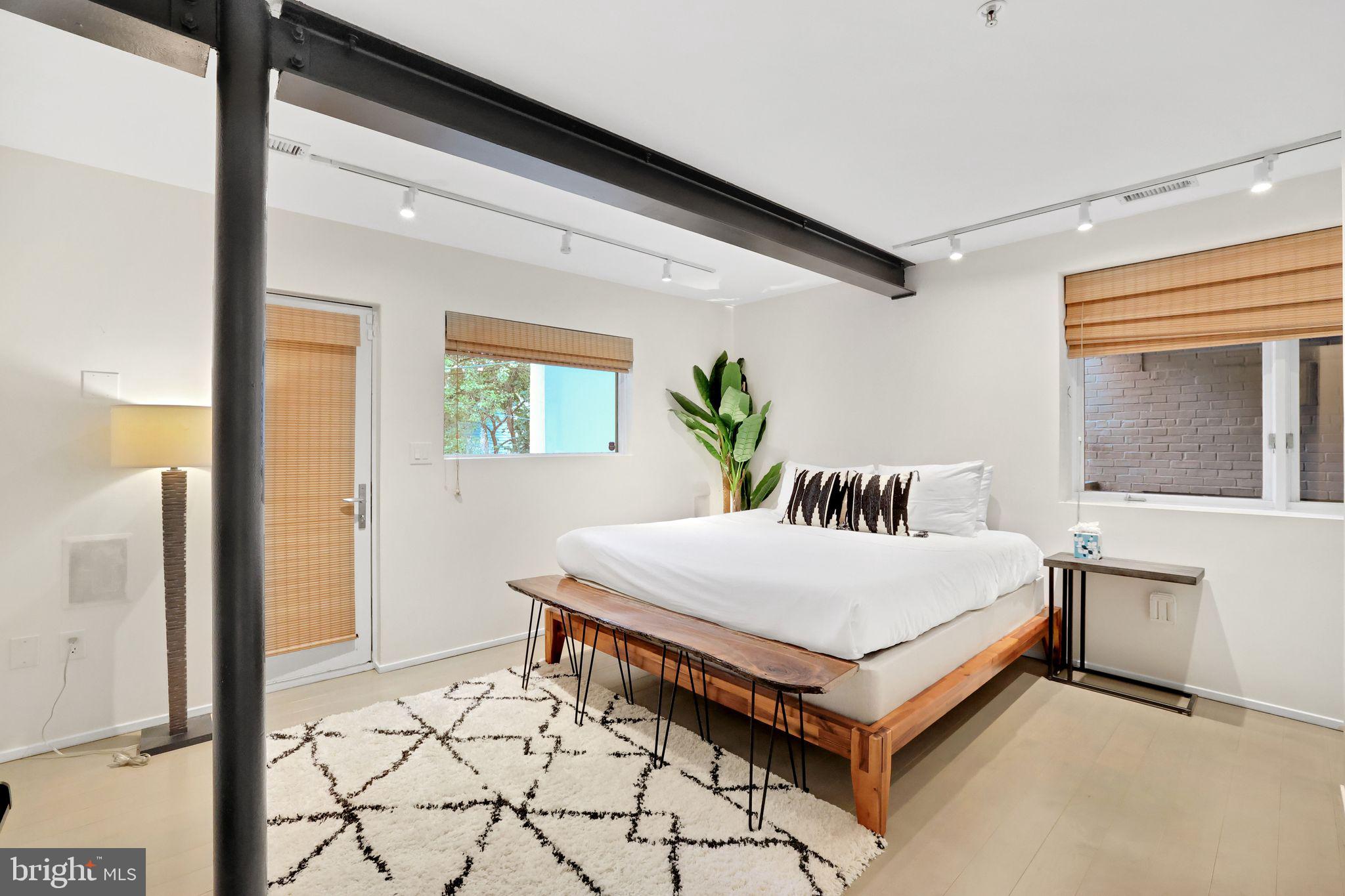 2311 15th Street Northwest, Unit 2 Washington, DC 20009 - Photo 16 of 37 a white bed sitting in a bedroom next to a window