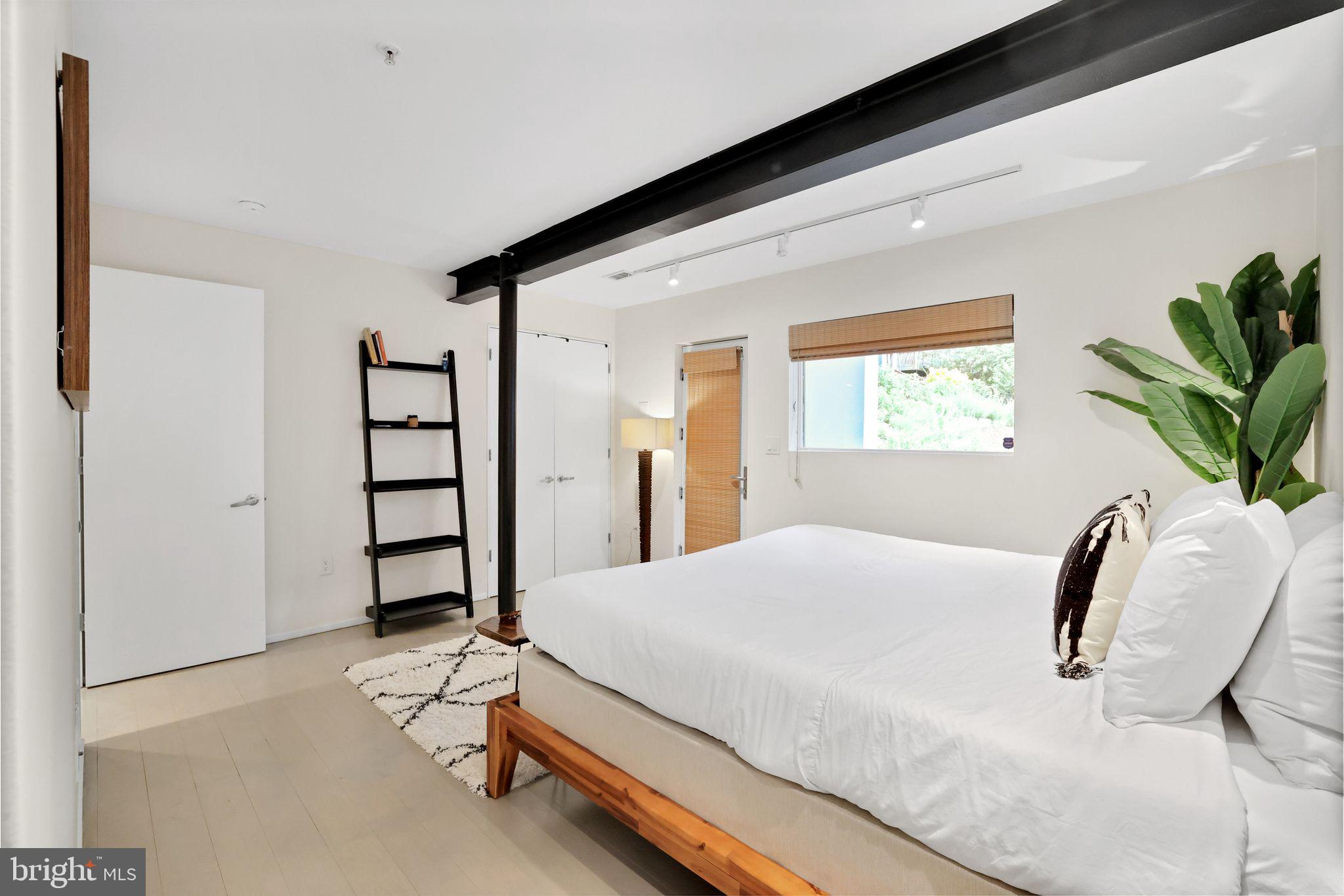 2311 15th Street Northwest, Unit 2 Washington, DC 20009 - Photo 17 of 37 a bedroom with a bed and a large mirror