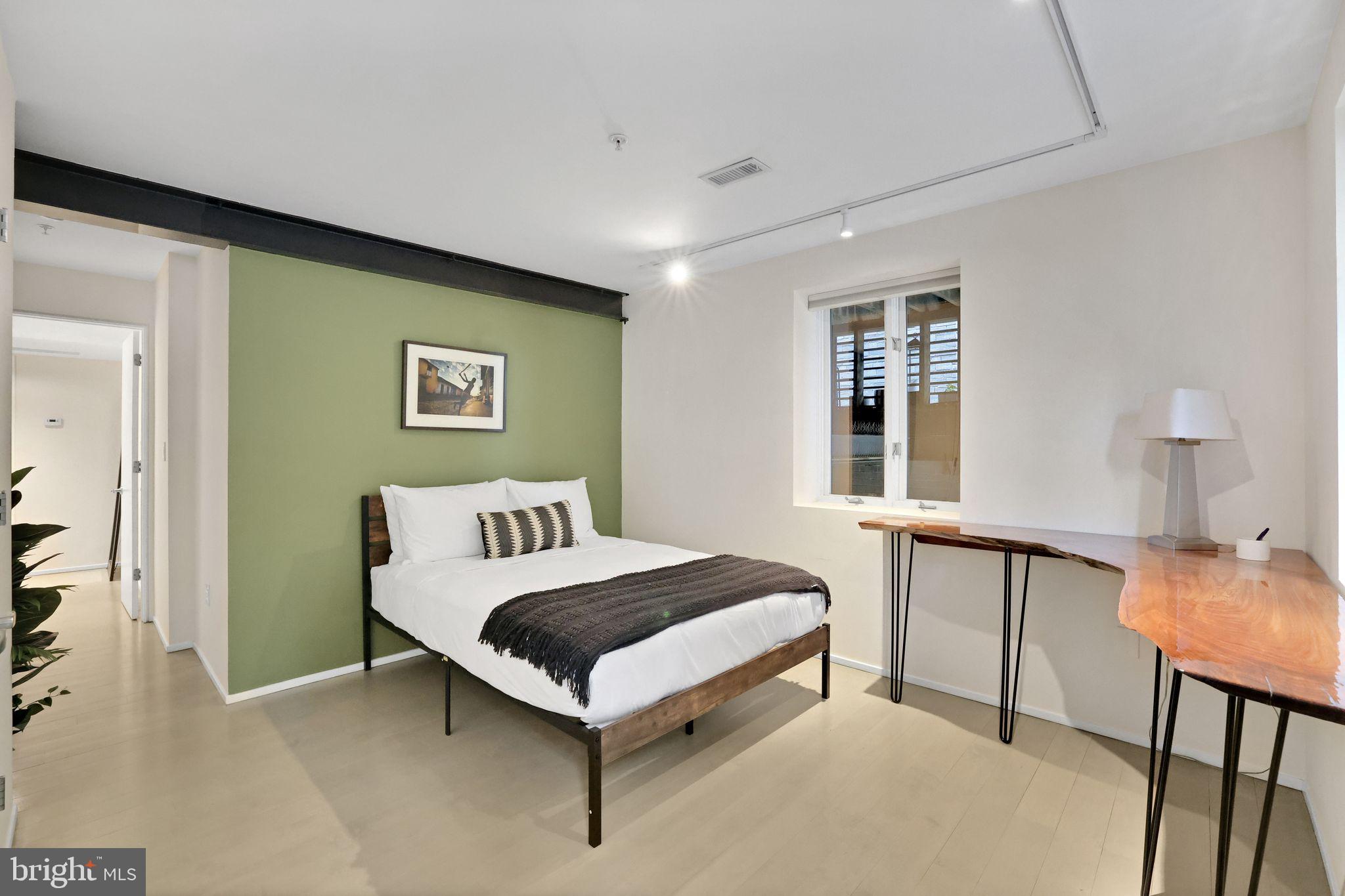 2311 15th Street Northwest, Unit 2 Washington, DC 20009 - Photo 23 of 37 a bedroom with a bed and a table in it