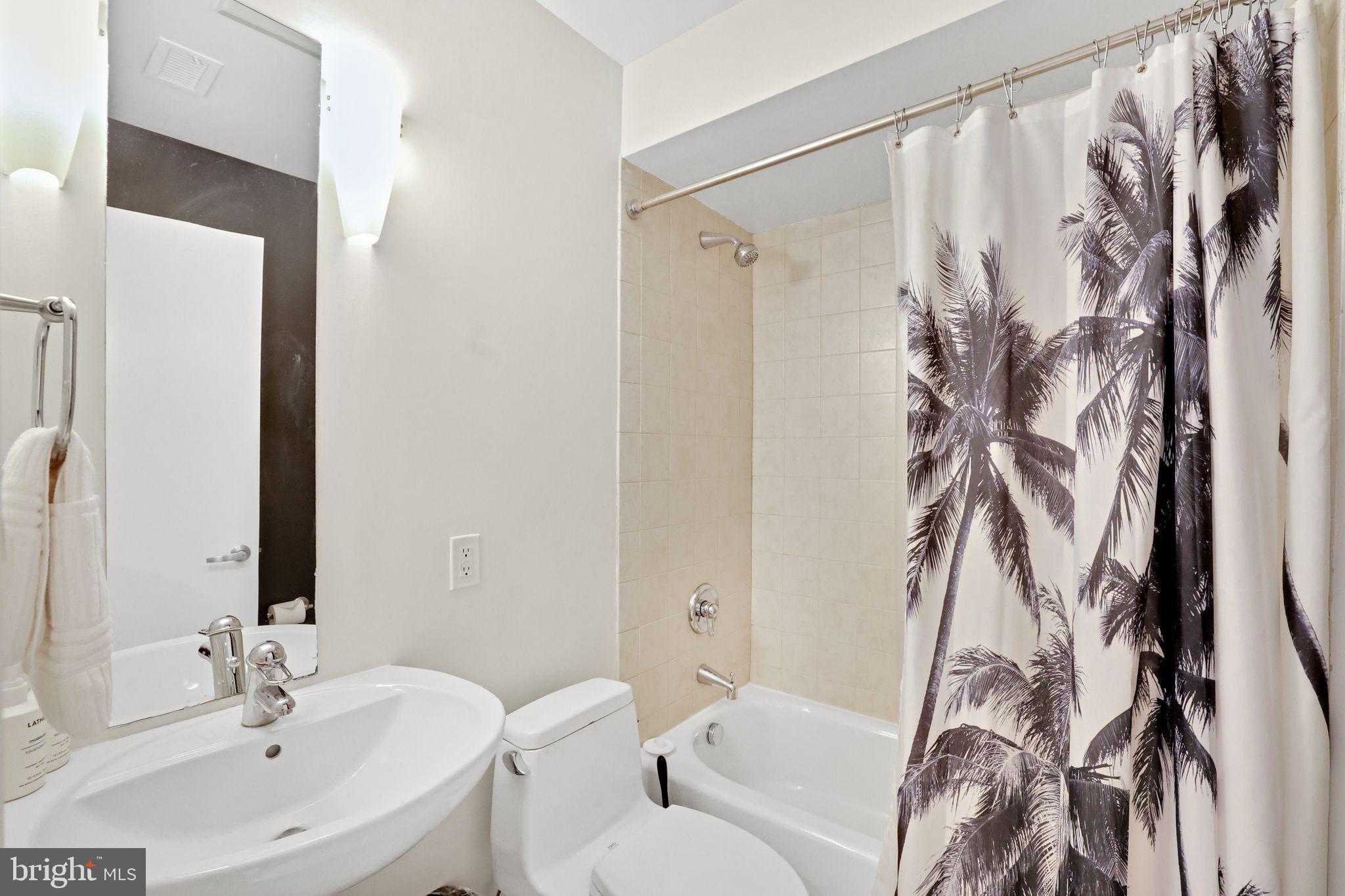 2311 15th Street Northwest, Unit 2 Washington, DC 20009 - Photo 24 of 37 a bathroom with a bathtub and shower curtain