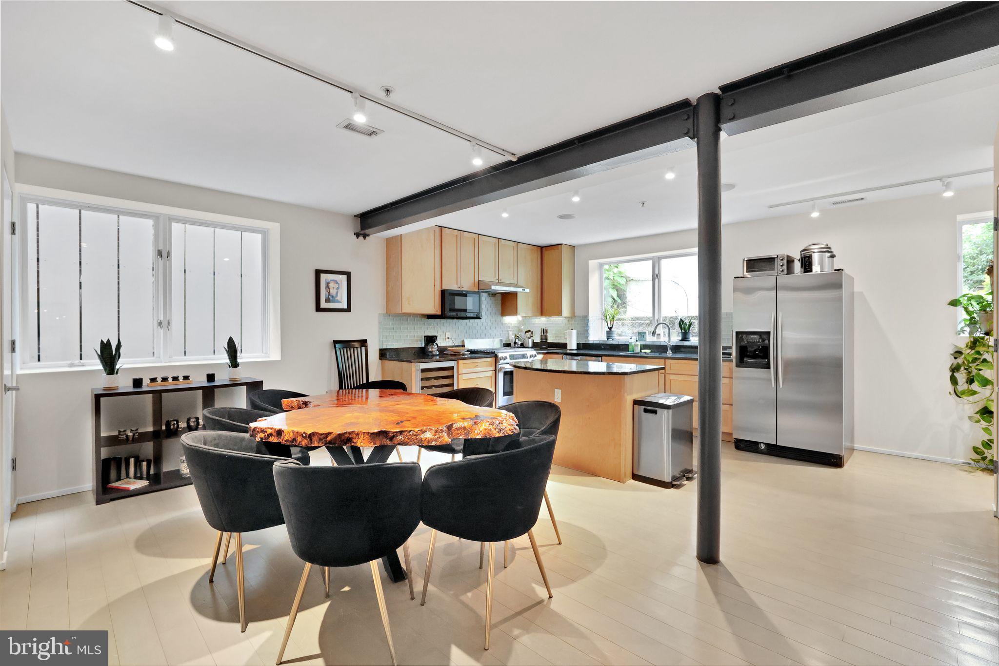 2311 15th Street Northwest, Unit 2 Washington, DC 20009 - Photo 9 of 37 a kitchen with stainless steel appliances granite countertop a stove a sink a refrigerator and chairs