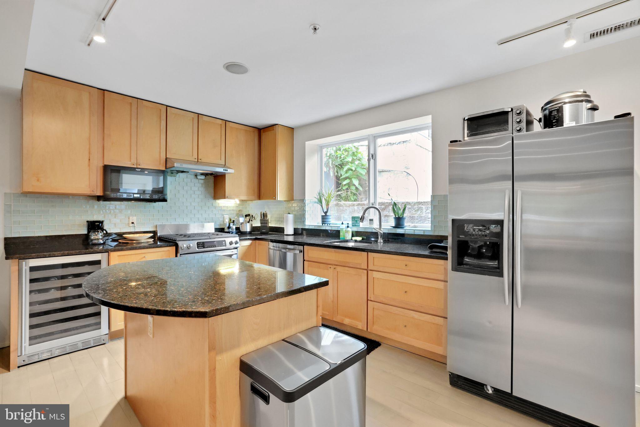 2311 15th Street Northwest, Unit 2 Washington, DC 20009 - Photo 10 of 37 a kitchen with stainless steel appliances granite countertop a refrigerator a sink and a stove