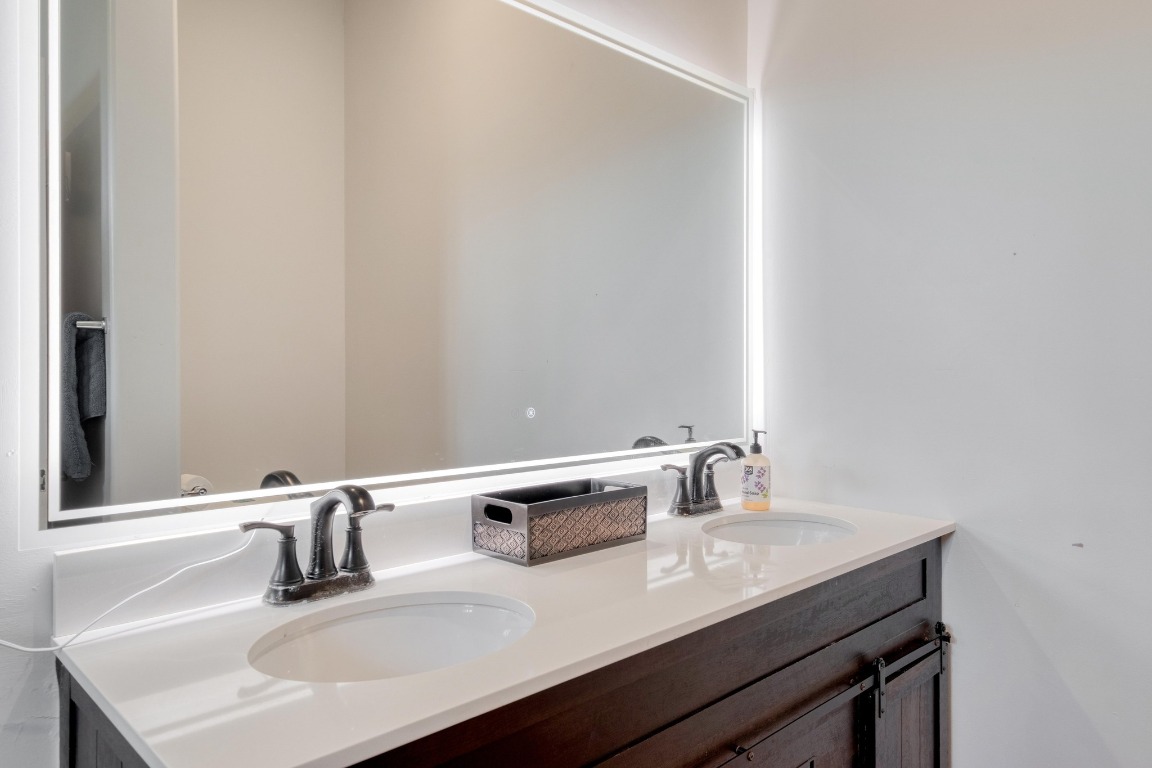 1601 County Road 466 Elgin, TX 78621 - Photo 13 of 39 a bathroom with a sink and a mirror