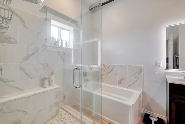 a bathroom with a sink a toilet and shower