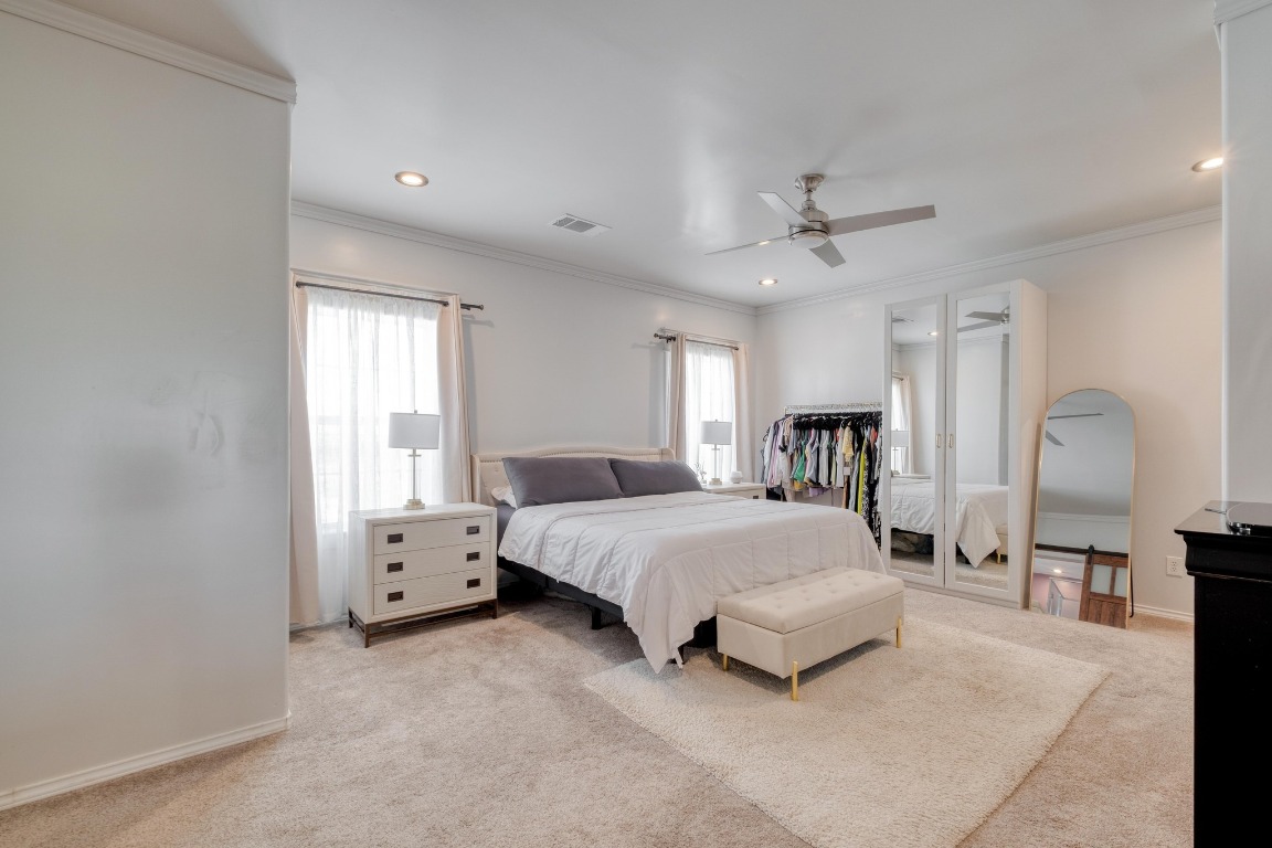 1601 County Road 466 Elgin, TX 78621 - Photo 17 of 39 a spacious bedroom with a bed a chandelier and window