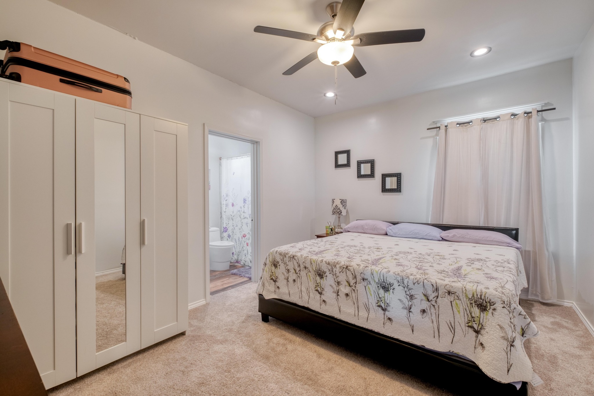 1601 County Road 466 Elgin, TX 78621 - Photo 21 of 39 a bedroom with a large bed and a chandelier