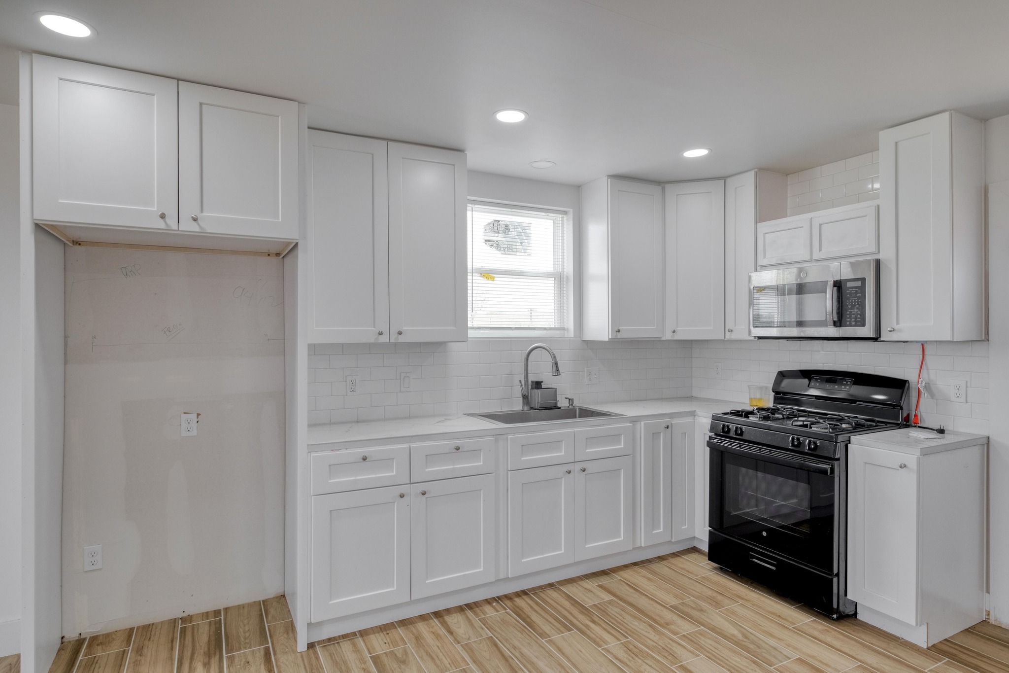 1601 County Road 466 Elgin, TX 78621 - Photo 35 of 39 a kitchen with white cabinets and appliances