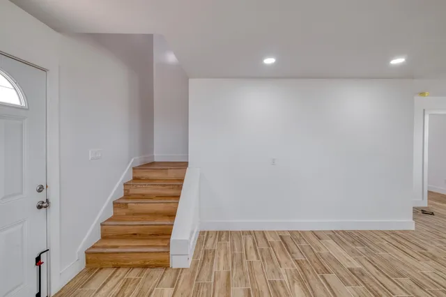 a bedroom with a bed window and a table