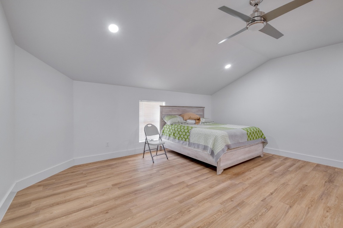1601 County Road 466 Elgin, TX 78621 - Photo 37 of 39 a bedroom with a bed window and wooden floor
