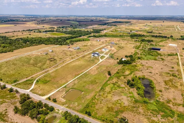 a kitchen with stainless steel appliances a sink a stove and white cabinets next to a window