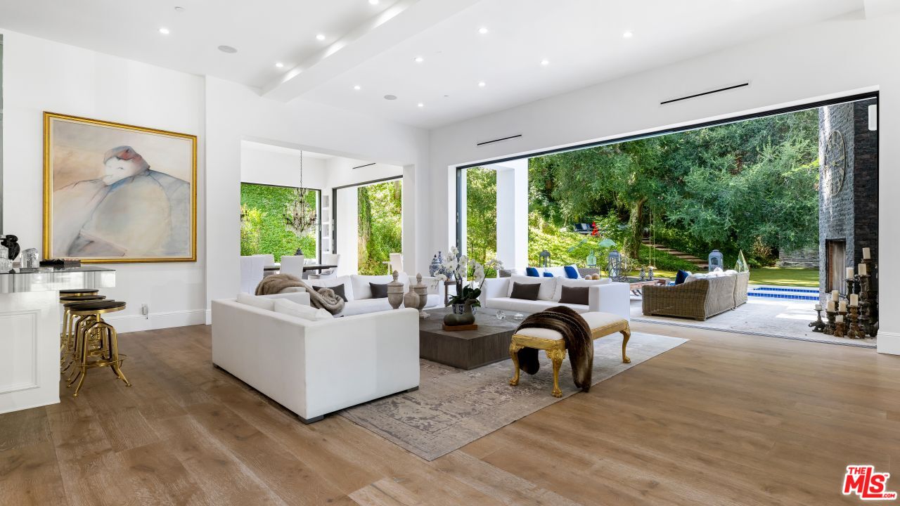 2231 Benedict Canyon Drive Beverly Hills, CA 90210 - Photo 11 of 50 a living room with furniture and a large window