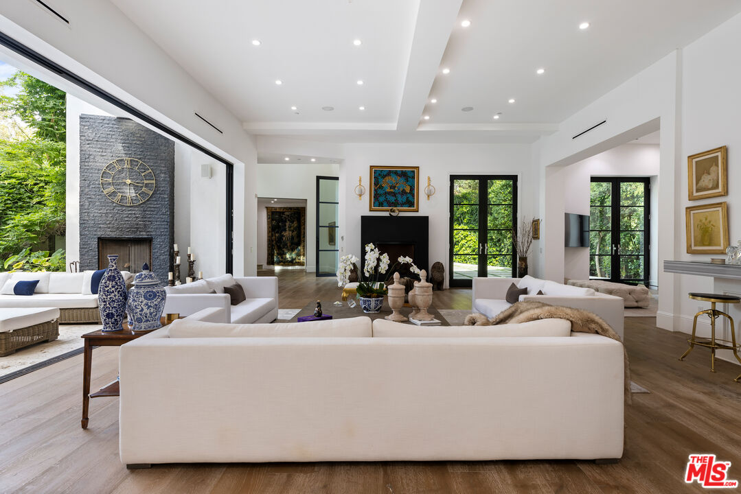 2231 Benedict Canyon Drive Beverly Hills, CA 90210 - Photo 12 of 50 a living room with furniture wooden floor and a large window