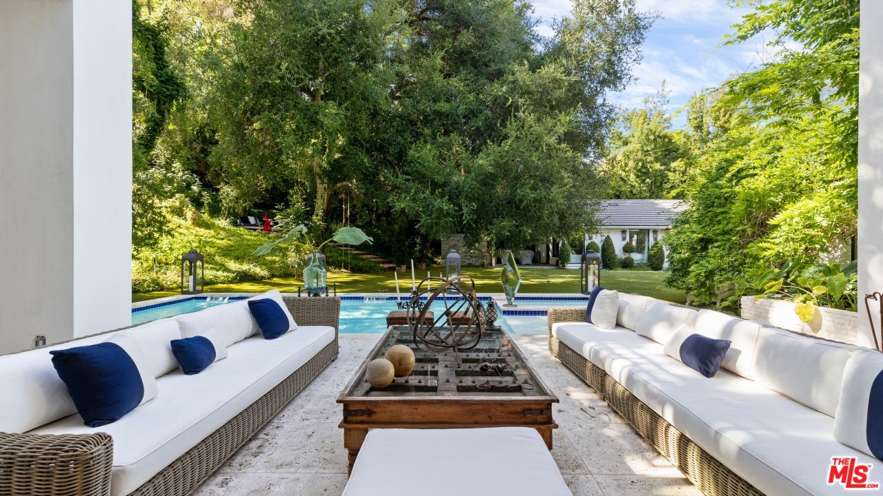 2231 Benedict Canyon Drive Beverly Hills, CA 90210 - Photo 15 of 50 a view of a patio with couches table and chairs with wooden fence