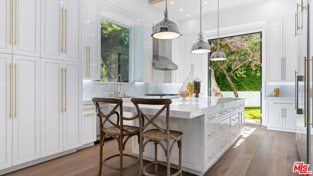 2231 Benedict Canyon Drive Beverly Hills, CA 90210 - Photo 18 of 50 a view of a dining room with furniture window and wooden floor