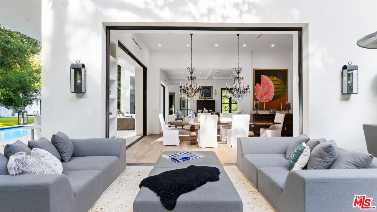 2231 Benedict Canyon Drive Beverly Hills, CA 90210 - Photo 20 of 50 a living room with furniture and a floor to ceiling window