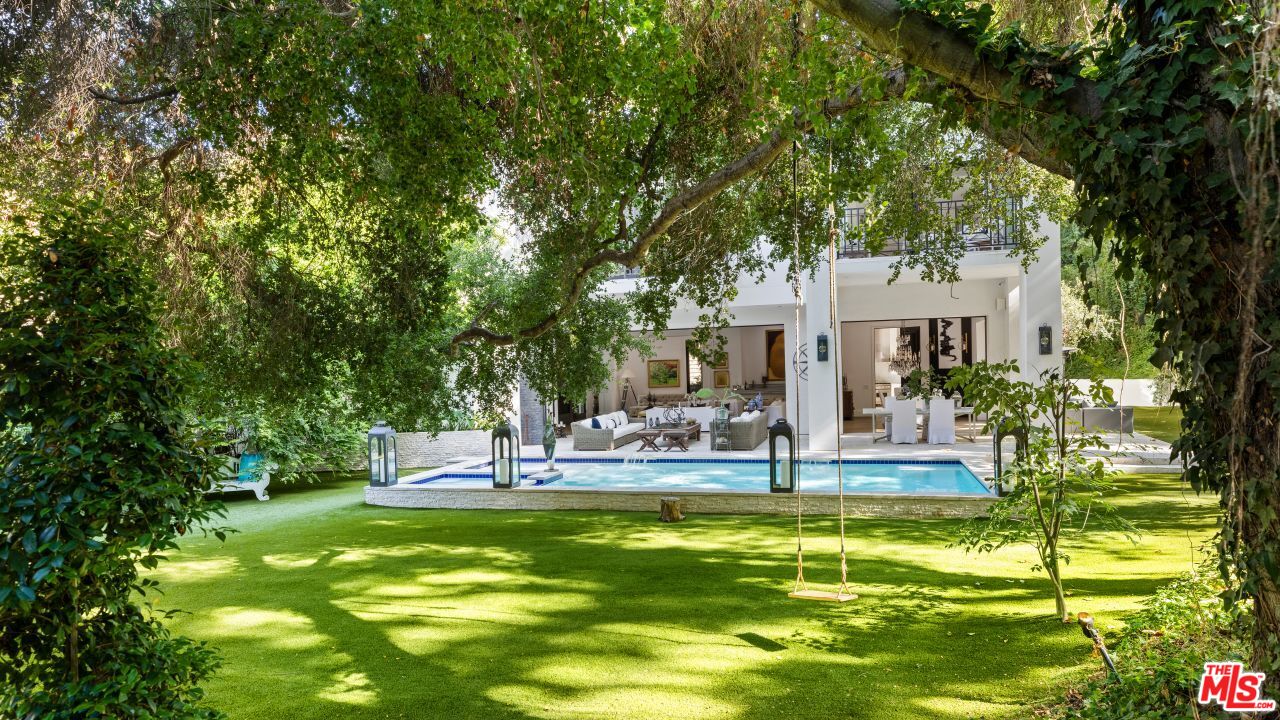 2231 Benedict Canyon Drive Beverly Hills, CA 90210 - Photo 23 of 50 a view of a house with swimming pool and sitting area