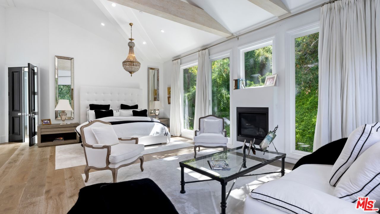 2231 Benedict Canyon Drive Beverly Hills, CA 90210 - Photo 25 of 50 a living room with furniture and a fireplace