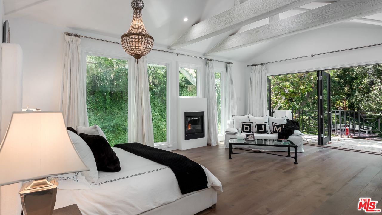 2231 Benedict Canyon Drive Beverly Hills, CA 90210 - Photo 26 of 50 a bedroom with bed and a large window
