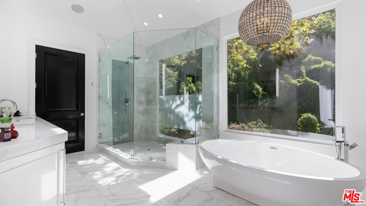 2231 Benedict Canyon Drive Beverly Hills, CA 90210 - Photo 30 of 50 a bathroom with a tub a mirror and shower