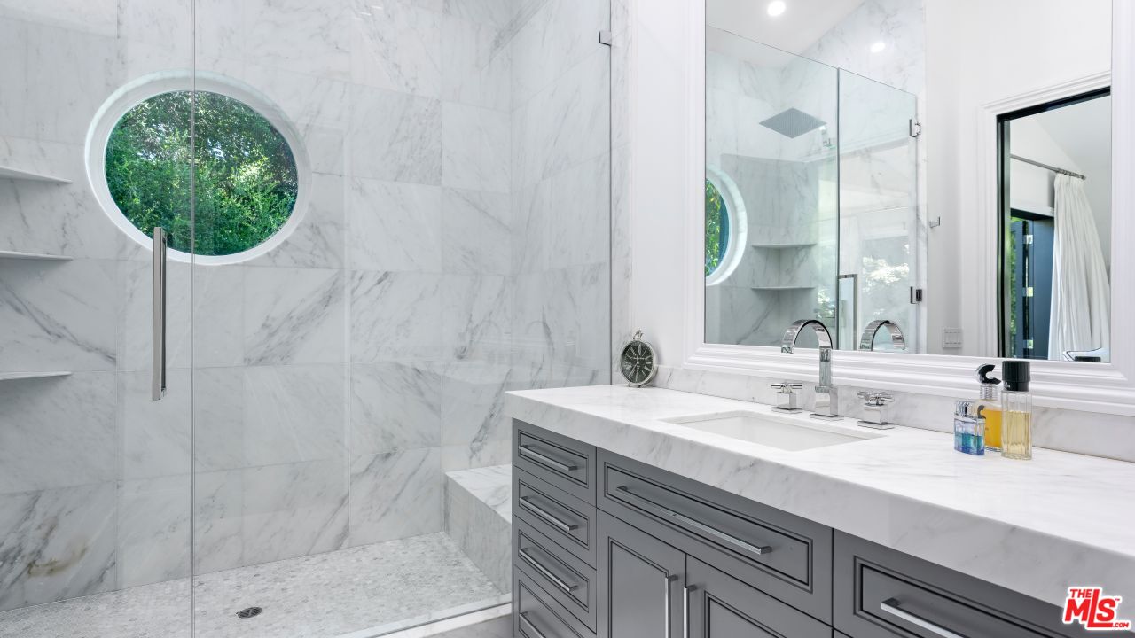 2231 Benedict Canyon Drive Beverly Hills, CA 90210 - Photo 32 of 50 a bathroom with a sink and a mirror