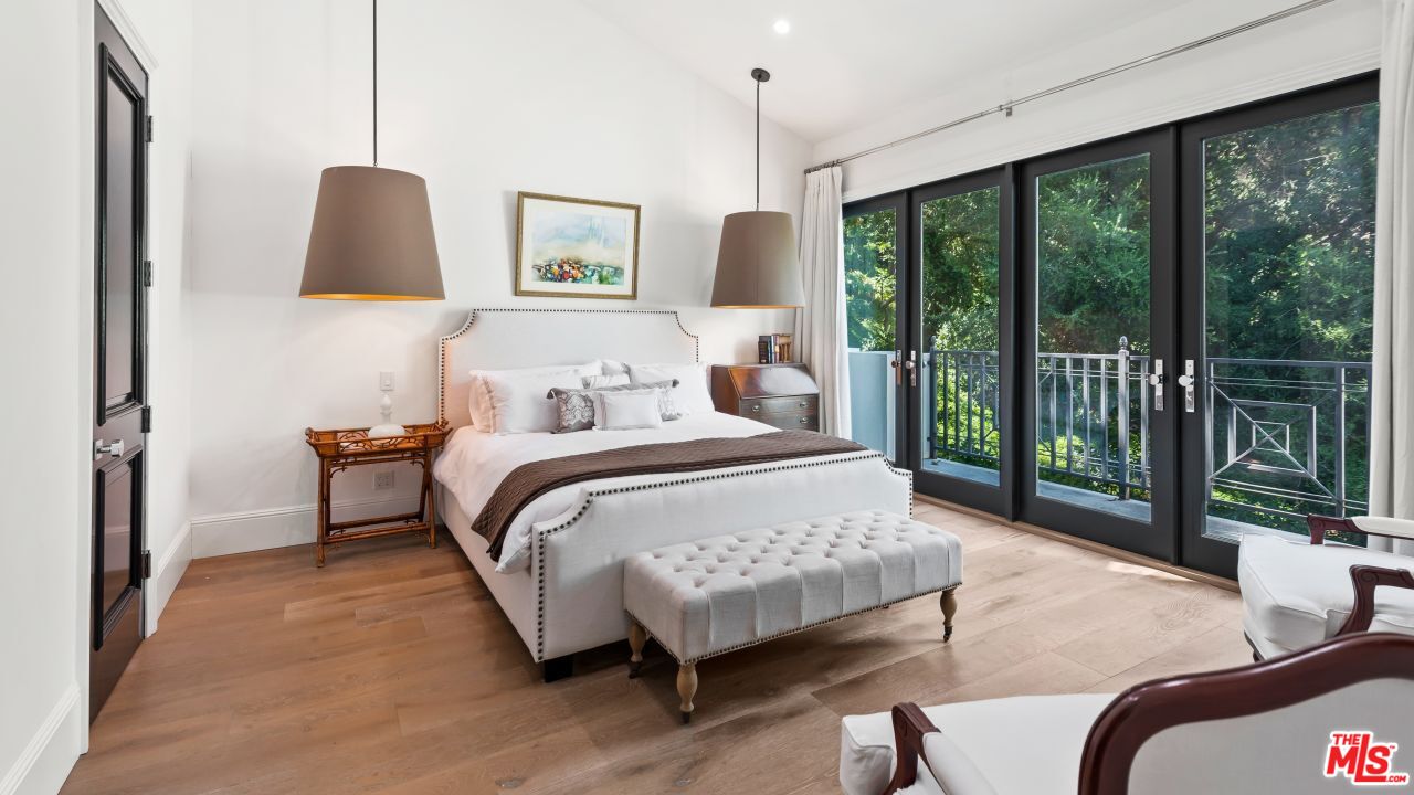 2231 Benedict Canyon Drive Beverly Hills, CA 90210 - Photo 35 of 50 a bedroom with a bed a lamp and window