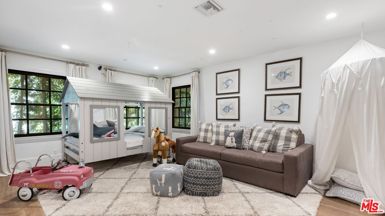 2231 Benedict Canyon Drive Beverly Hills, CA 90210 - Photo 37 of 50 a living room with furniture and a large window