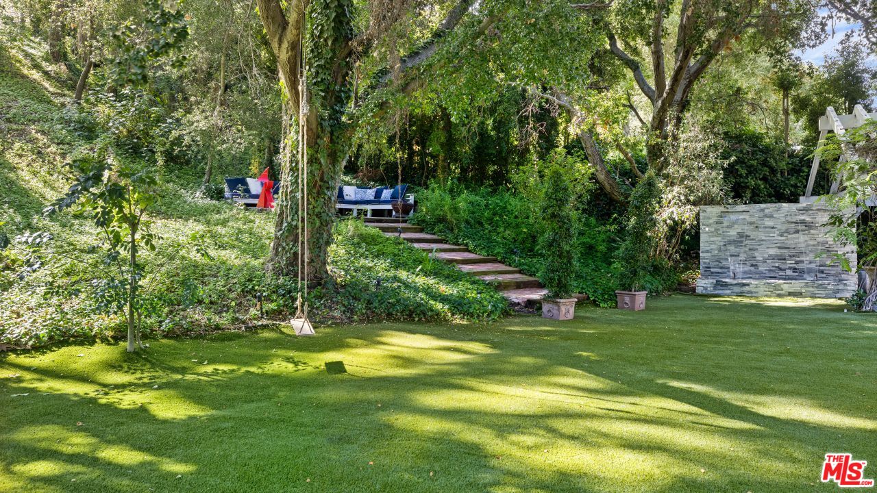 2231 Benedict Canyon Drive Beverly Hills, CA 90210 - Photo 40 of 50 a view of swimming pool with a garden and trees