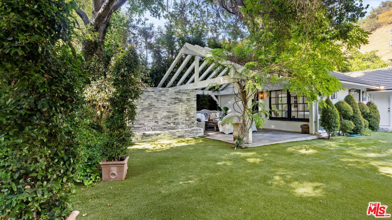 2231 Benedict Canyon Drive Beverly Hills, CA 90210 - Photo 42 of 50 a view of a house with a yard