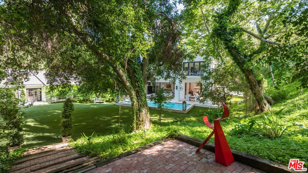 2231 Benedict Canyon Drive Beverly Hills, CA 90210 - Photo 44 of 50 a front view of a house with garden