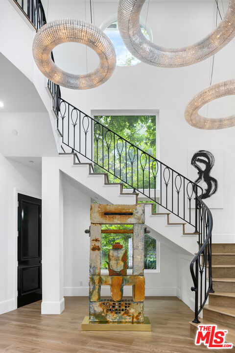 2231 Benedict Canyon Drive Beverly Hills, CA 90210 - Photo 9 of 50 a front view of a house with wooden floor swimming pool and dining table