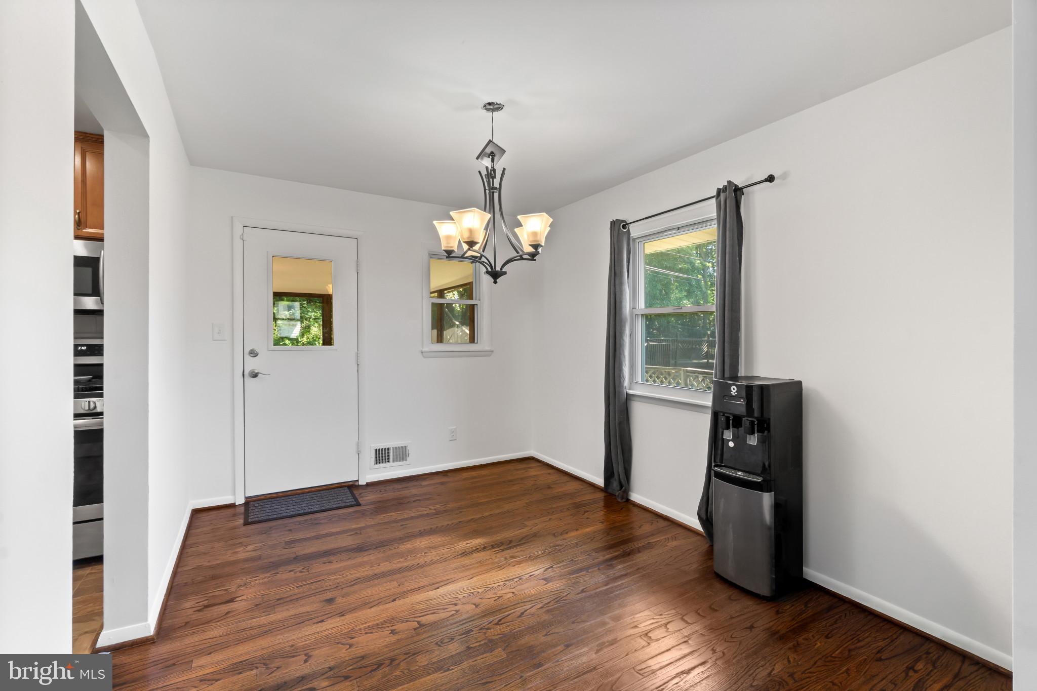 415 Baylor Road Glen Burnie, MD 21061 - Photo 6 of 29 an empty room with wooden floor and windows