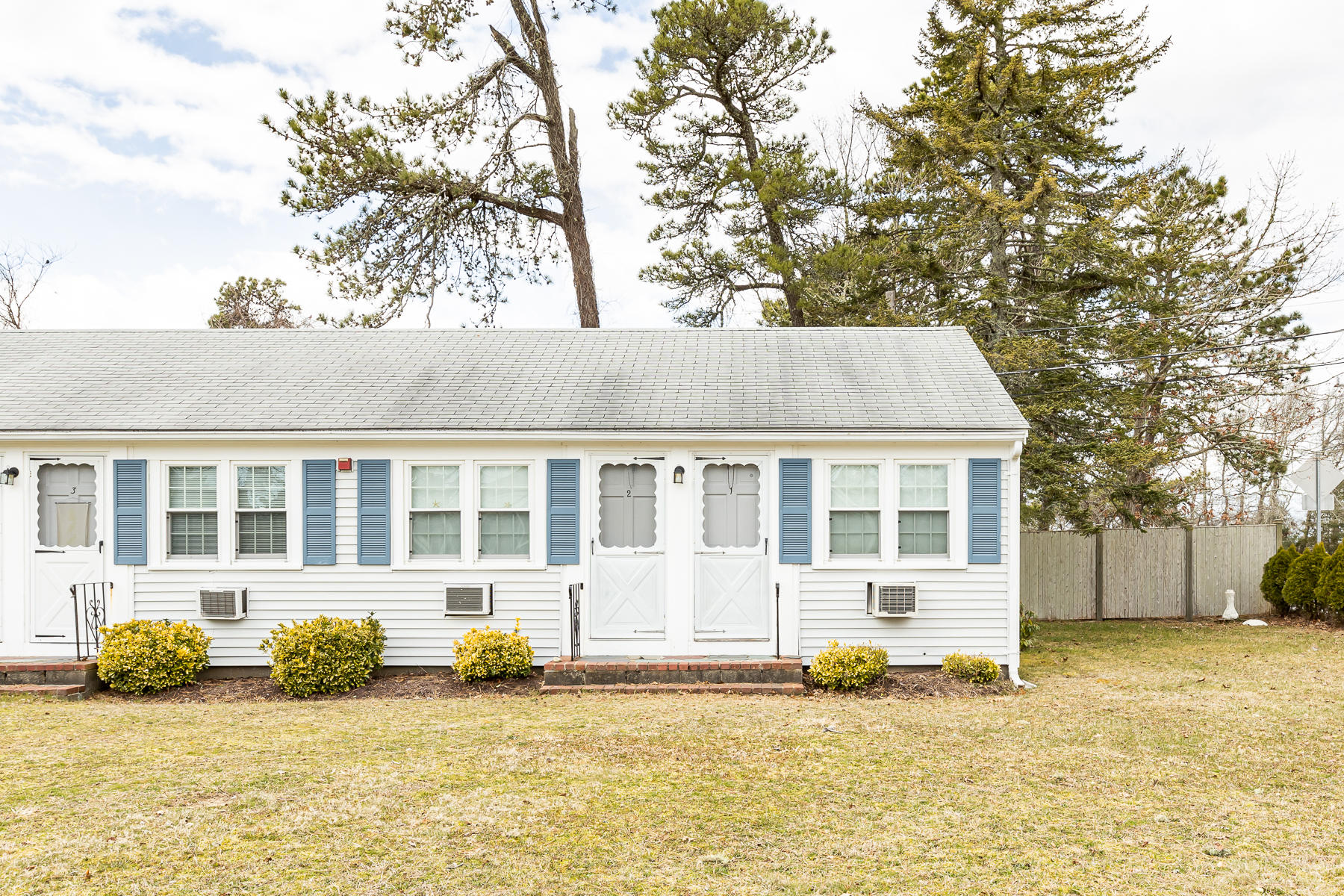 49 Lower County Road Dennis, MA 02639 - Photo 1 of 19 a view of a white house with a large tree in front of it