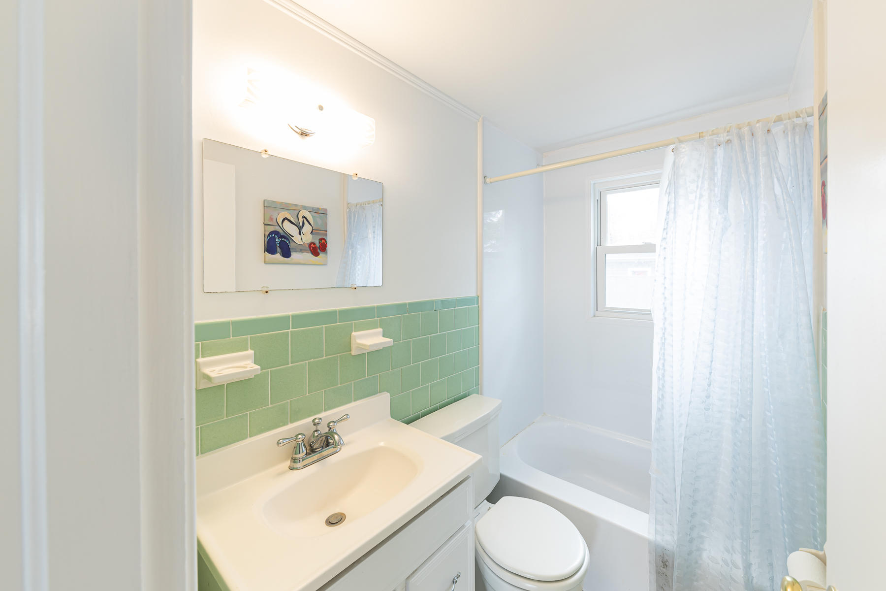 49 Lower County Road Dennis, MA 02639 - Photo 16 of 19 a bathroom with a sink mirror toilet and bathtub