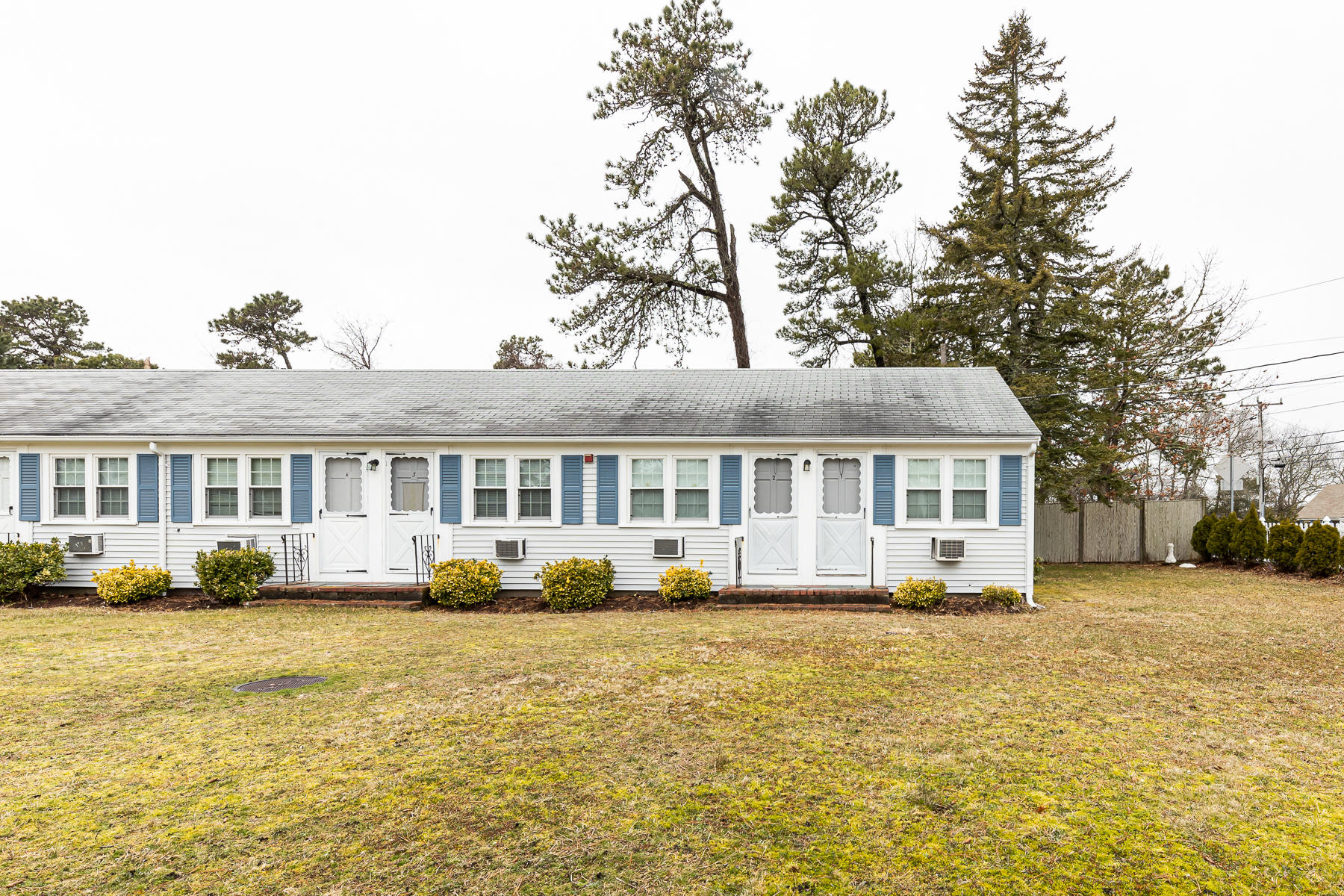 49 Lower County Road Dennis, MA 02639 - Photo 2 of 19 a front view of a house with a garden and trees