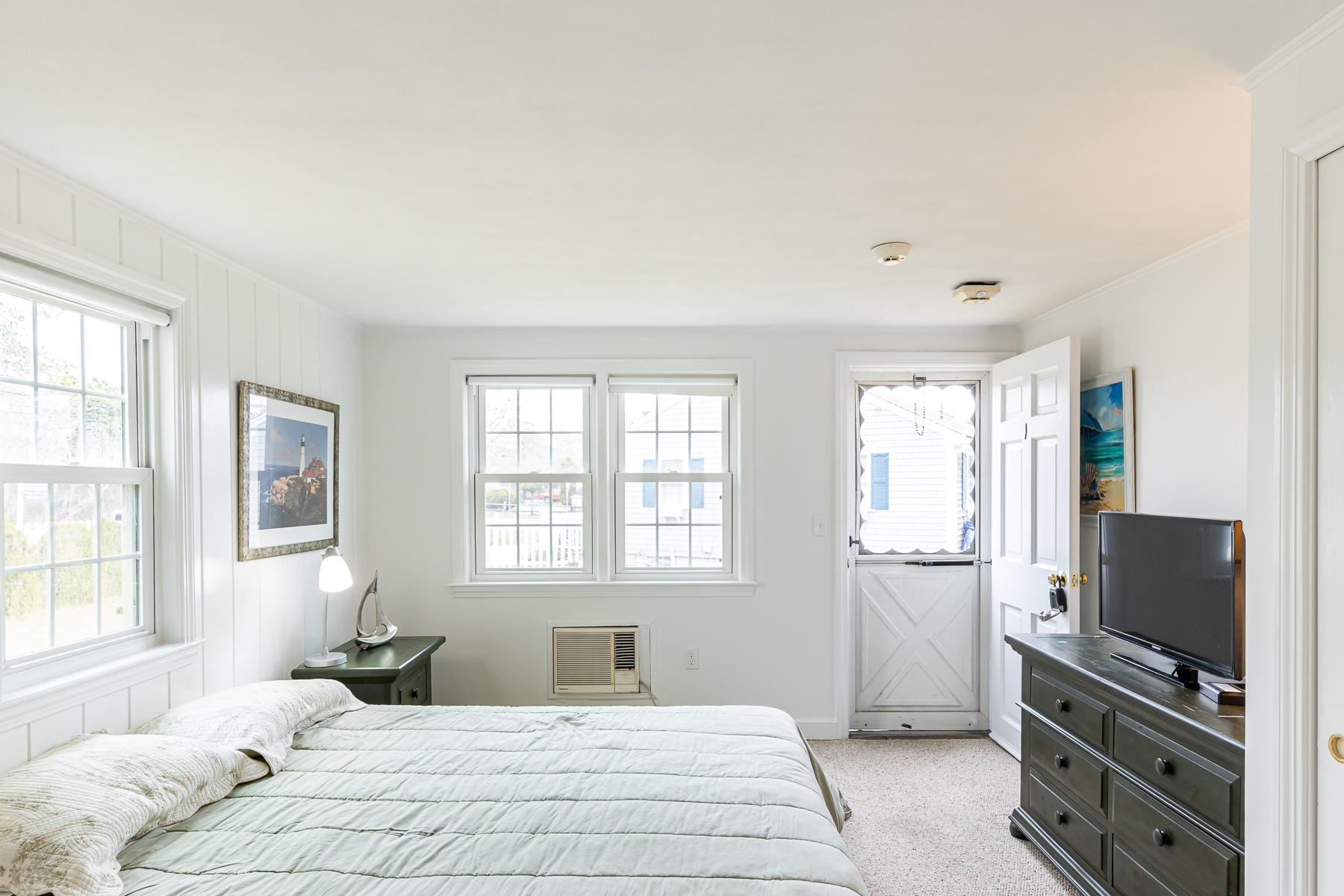 49 Lower County Road Dennis, MA 02639 - Photo 10 of 19 a bedroom with a bed and a flat screen tv