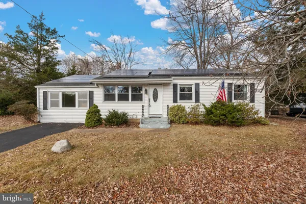 a front view of house with yard and trees around