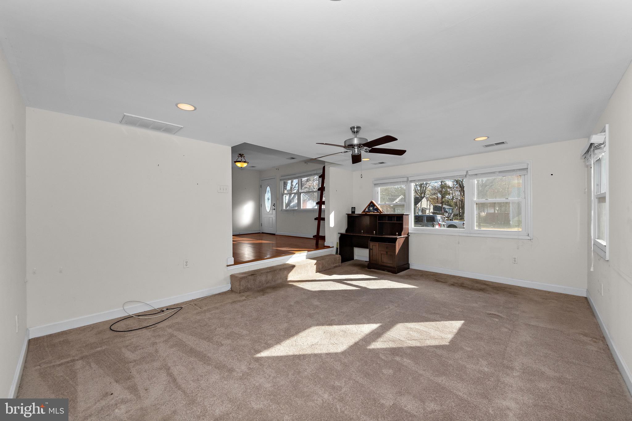 115 Valley View Avenue Edgewater, MD 21037 - Photo 16 of 56 a view of a livingroom with wooden floor and a ceiling fan