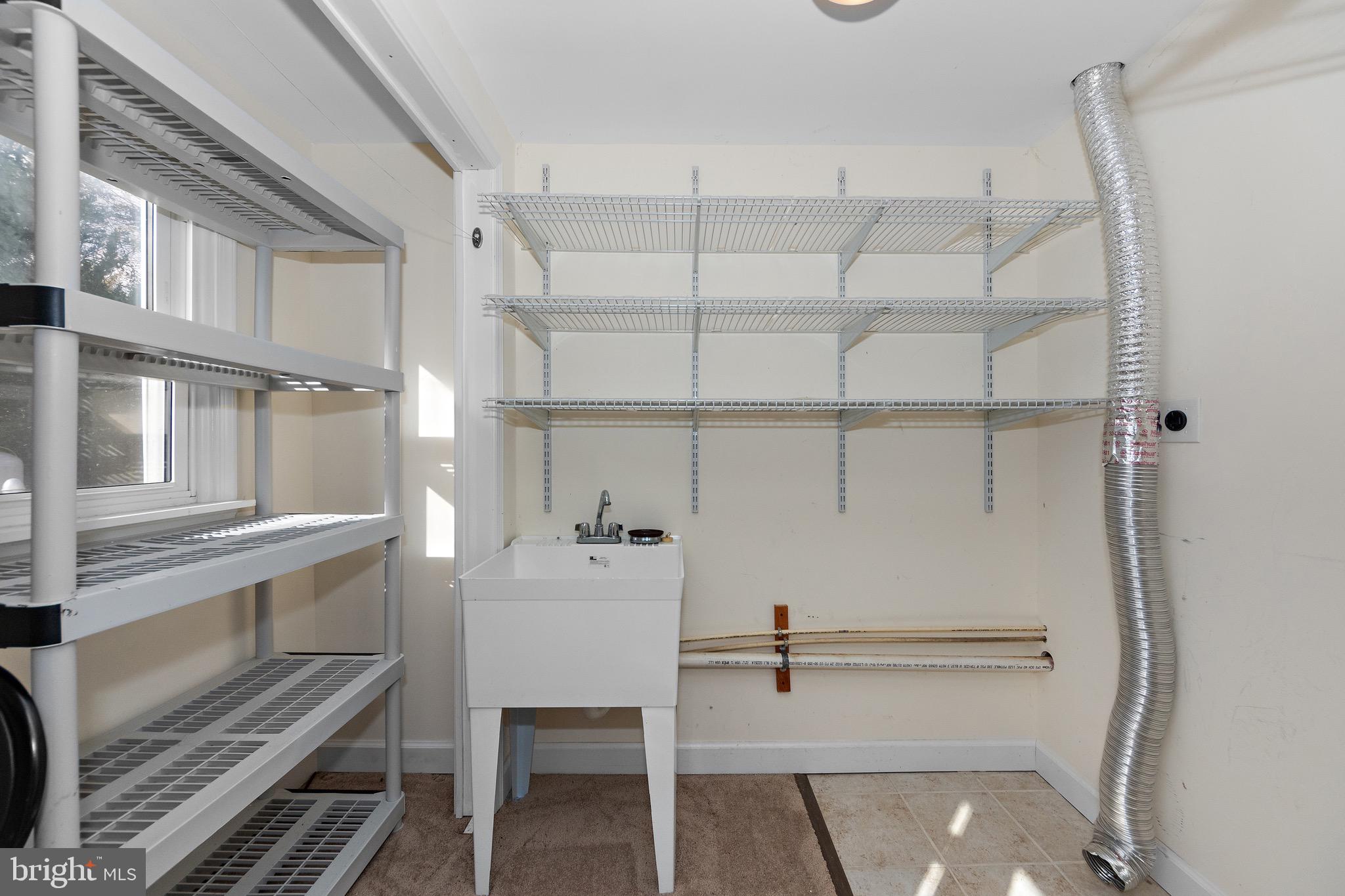 115 Valley View Avenue Edgewater, MD 21037 - Photo 21 of 56 a view of cabinets and utility room with racks on the wall