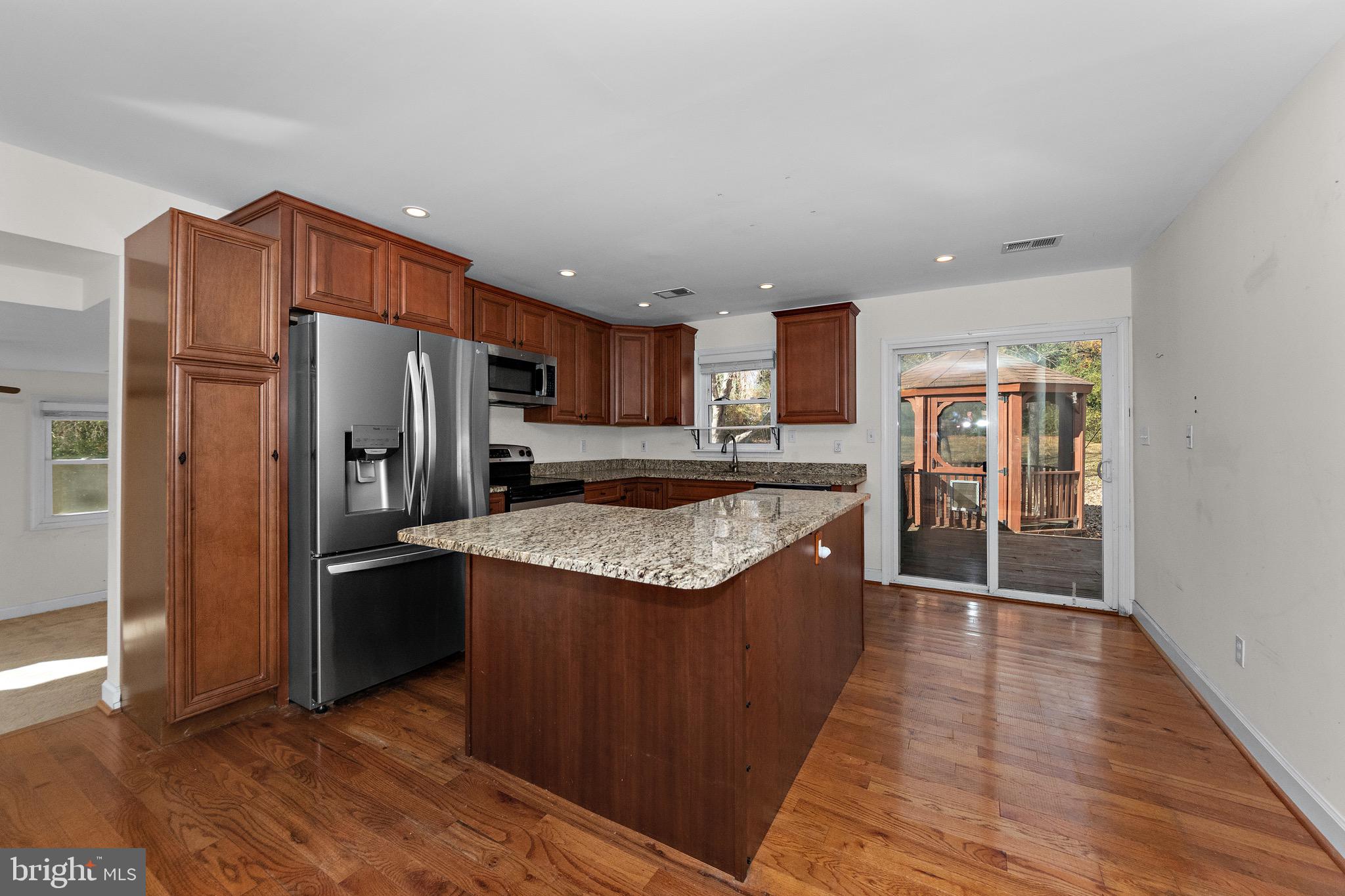 115 Valley View Avenue Edgewater, MD 21037 - Photo 3 of 56 a kitchen with stainless steel appliances granite countertop a refrigerator a sink a stove and oven