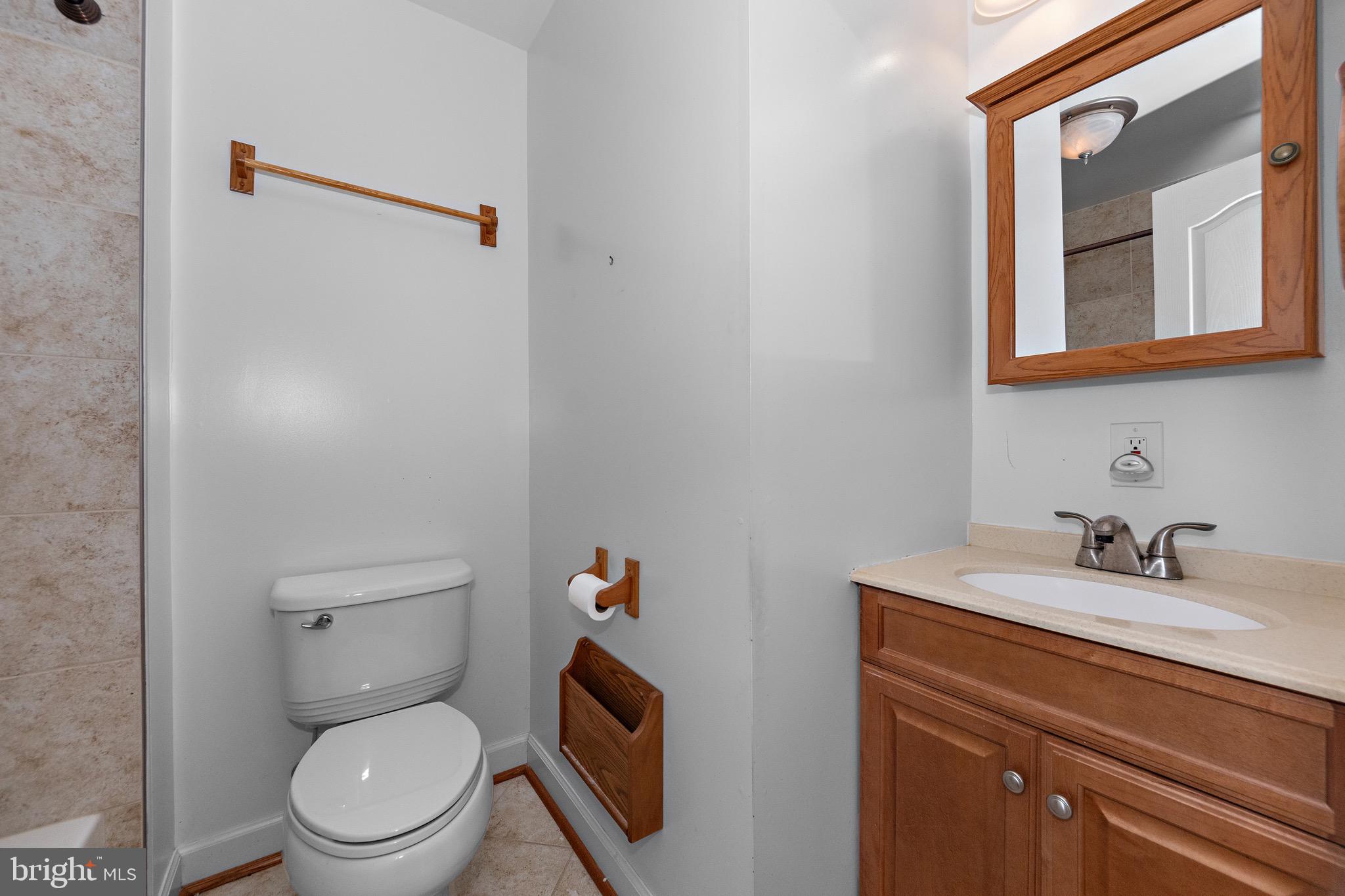 115 Valley View Avenue Edgewater, MD 21037 - Photo 36 of 56 a bathroom with a toilet sink vanity and mirror